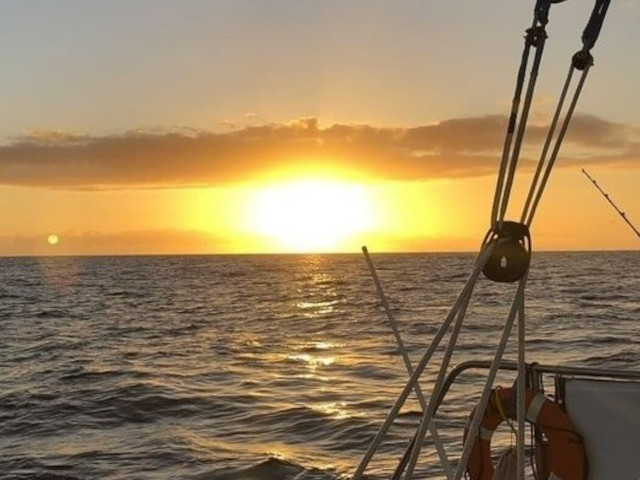 Sunset over the ocean viewed from the Maitaʻi Catamaran