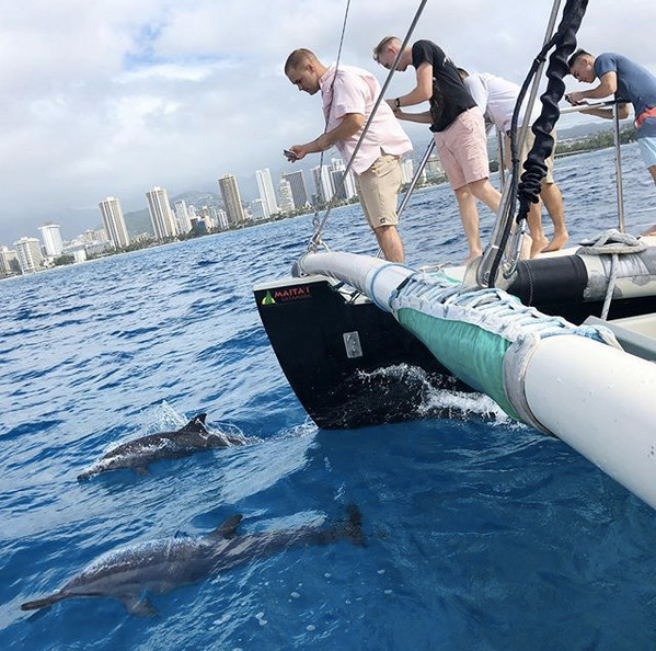 Passengers and crew on the catamaran with Waikiki in the background
