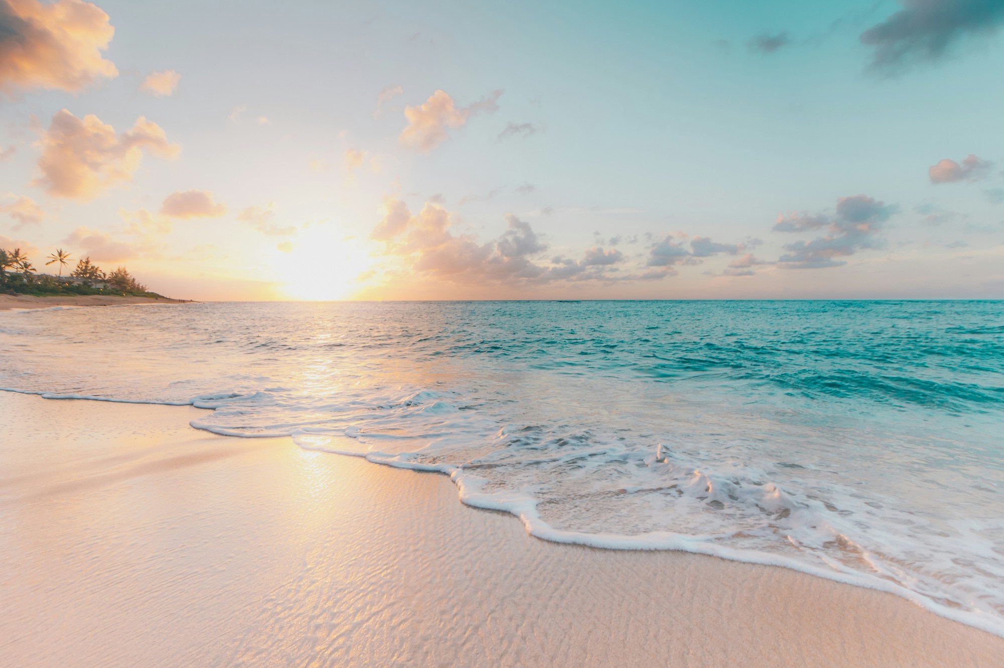 The Waikiki shoreline and ocean at sunset